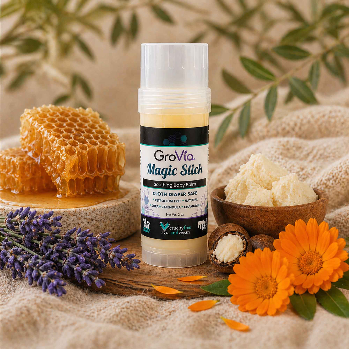GroVia Magic Stick with honeycomb, lavender, and flowers on a natural background