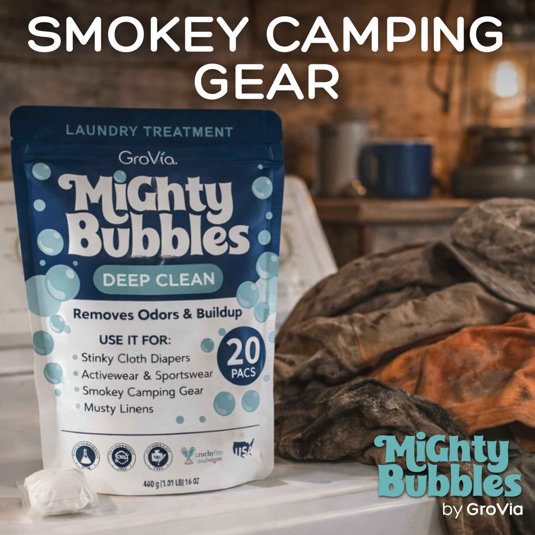 Mighty Bubbles laundry treatment packaging with camping gear in the background
